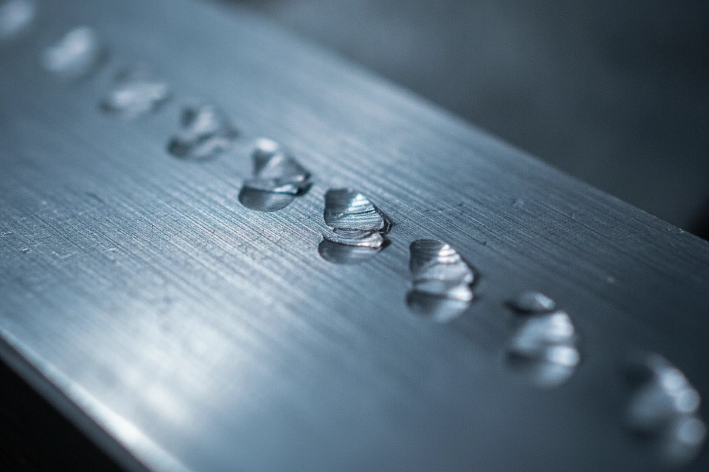 Machined tool steel item struck in a buyer's own marking format on a face that survives the finished part