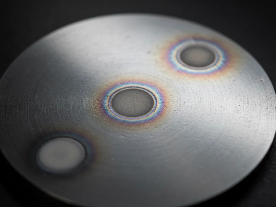 Burn spots left on a spectrometer sample after the analysis was taken