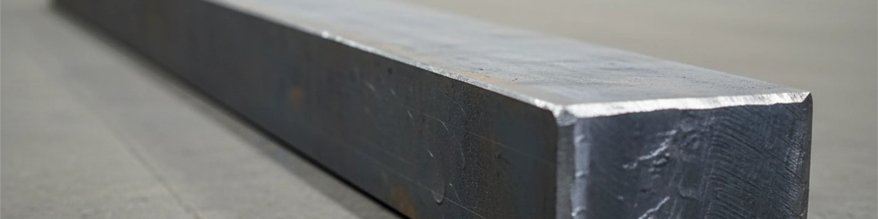 Forged H11 tool steel bar lying along its rolling and forging direction on the finishing bay