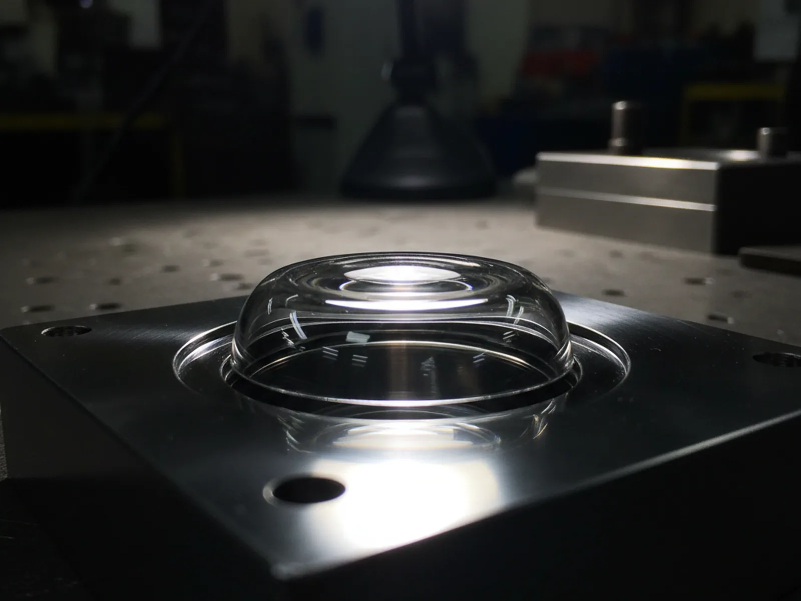 Transparent optical part beside the mirror polished mold steel cavity that formed it