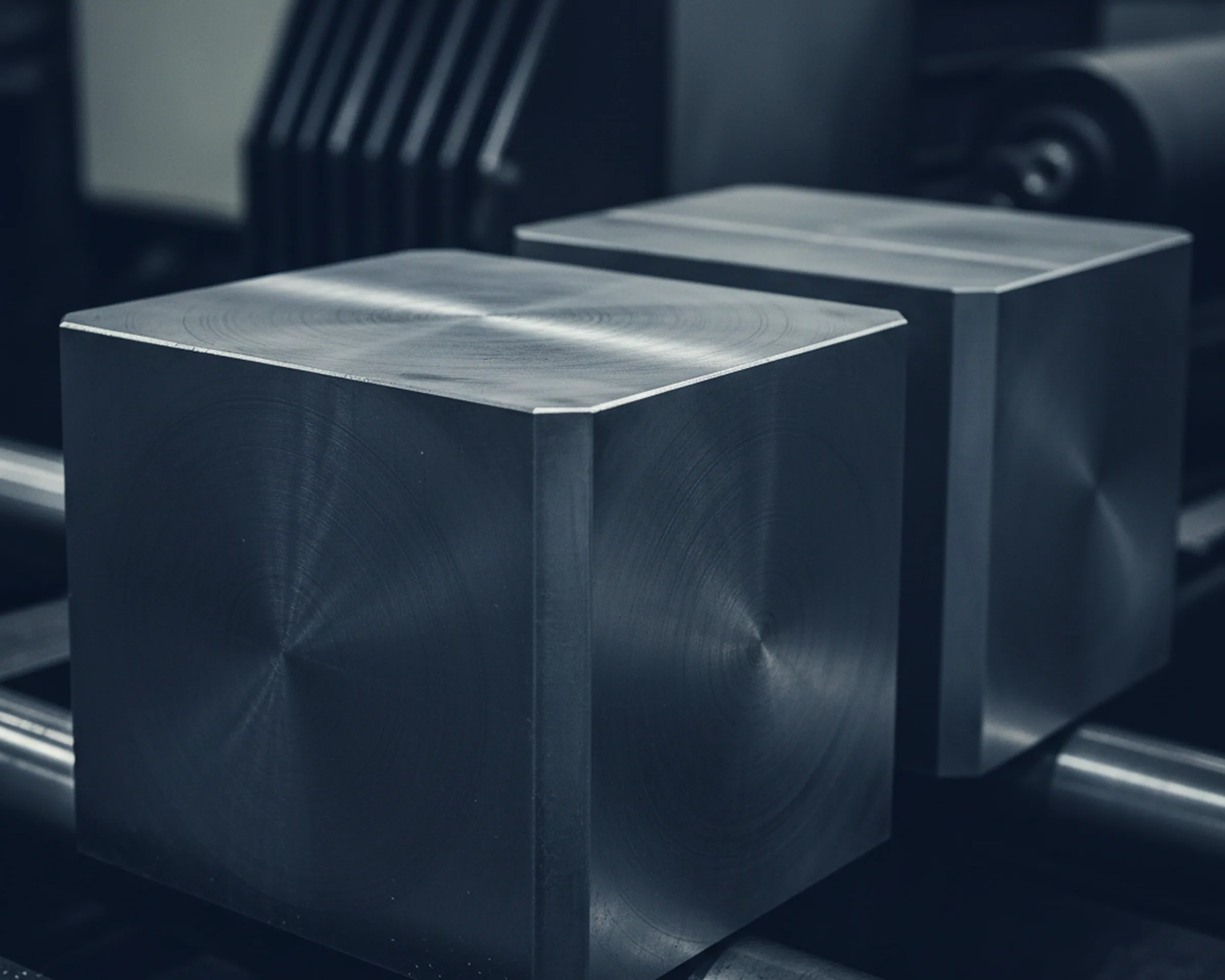 Six face milled tool steel block on the outfeed of a CNC gantry mill with all six faces cut